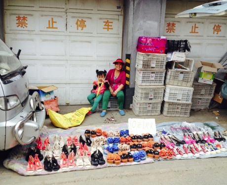 Selling shoes in a street market.